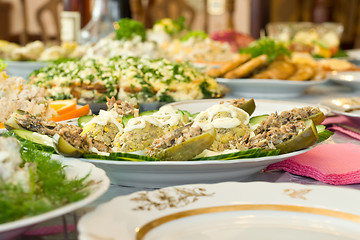 Image showing Banquet in the restaurant. Stuffed eggs and cucumbers