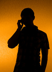 Image showing Silhouette of man speak over the phone