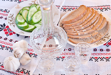 Image showing Vodka, bread and sliced cucumber