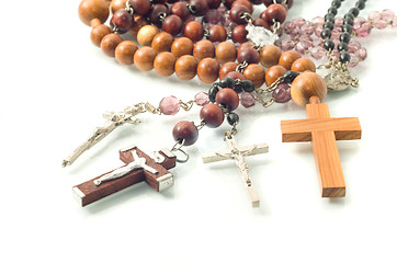 Image showing Rosary beads over white with focus on crosses 