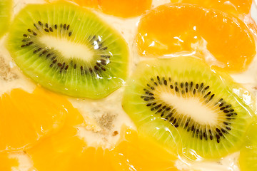 Image showing Fruit background. Kiwi and mandarin