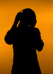 Image showing Music fan. Silhouette of man with earphones