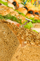 Image showing Cut Bread with seeds, meat and canape 
