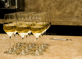 Image showing Glasses with white wine and opener on marble