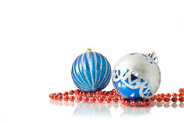 Image showing Christmas comes -  two blue balls and red beads