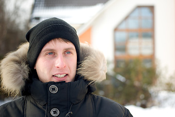 Image showing Winter - happy man in cap and warm jacket
