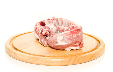 Image showing Uncooked pork meat on round hardboard