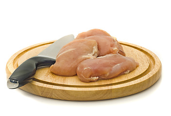 Image showing Chicken fillet and knife on hardboard