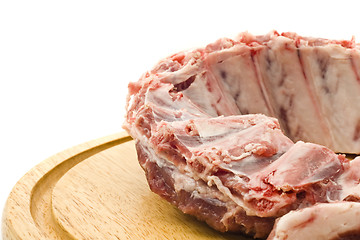 Image showing Pork ribs with raw meat on round hardboard