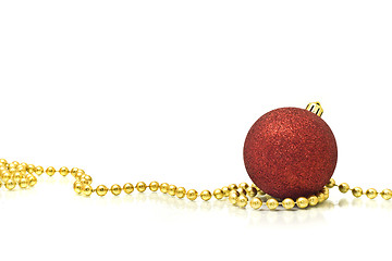 Image showing Christmas. Colorful red ball and golden beads