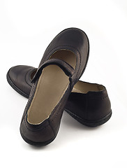 Image showing Women's black leather shoes over white