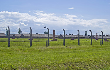 Image showing Wire fence and barracks in Birkenau concentration camp