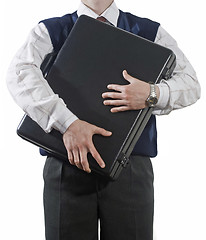 Image showing Businessman clasping case to breast