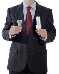 Image showing Businessman with old and energy-saving light bulbs