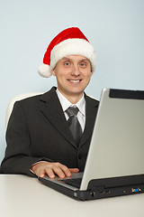 Image showing Man in festive Christmas mood with laptop