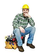 Image showing young handyman sit on toolbox