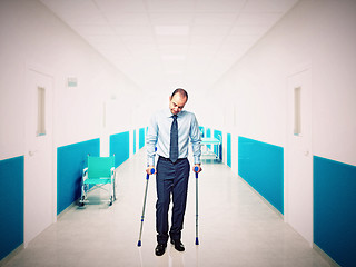 Image showing man with crutch in hospital