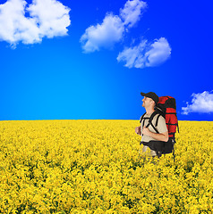 Image showing happy backpackers in flowers field