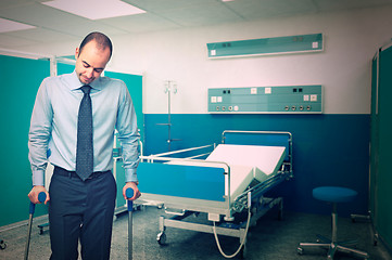 Image showing man with crutch in hospital
