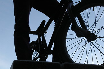 Image showing Man standing with a bmx bike