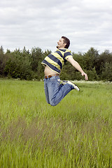 Image showing man jumps on a grass