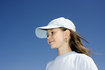 Image showing The smiling girl against a dark blue clear sky