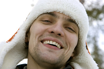 Image showing The young man in a winter cap against the sky