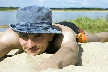 Image showing man lying on a beach