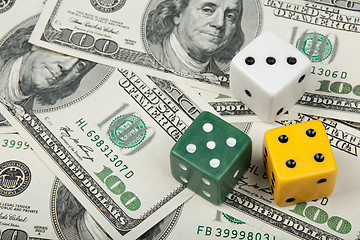 Image showing Dices of different colors on money background