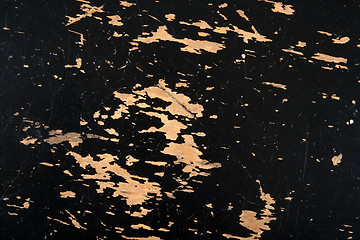 Image showing Peeled paint on black wooden surface