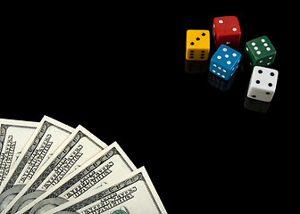 Image showing Colorful dices and money on black background