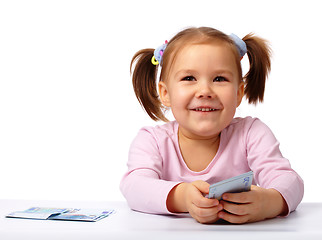 Image showing Little girl with few paper euro banknotes