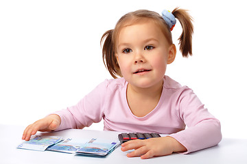 Image showing Little girl with few paper euro banknotes