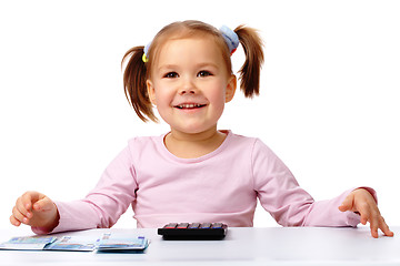 Image showing Little girl with few paper euro banknotes