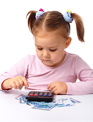 Image showing Little girl plays with money