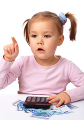 Image showing Little girl plays with money