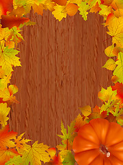 Image showing Fall leaves and pumpkins on wood background.