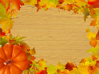 Image showing Fall leaves and pumpkins on wood background.