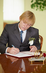 Image showing Groom solemnly signed documents