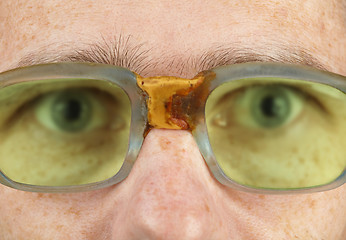 Image showing Person in old bad spectacles with poor eyesight