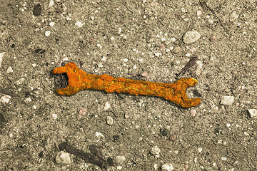 Image showing Old rusty wrench on ground