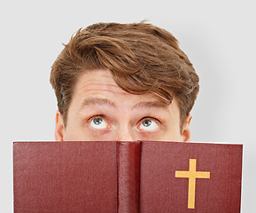 Image showing Young man thinks after bible reading