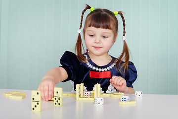 Image showing Little girl playing with dominoes