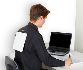 Image showing Man busy with work. On back attached piece of paper