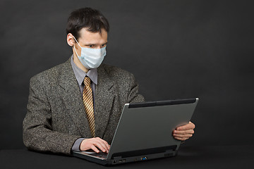 Image showing Person with medical mask working in Internet