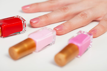 Image showing Women's hand and three bottles nail polish