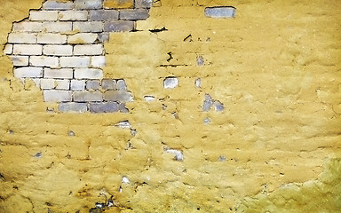 Image showing Brick wall with broken plaster