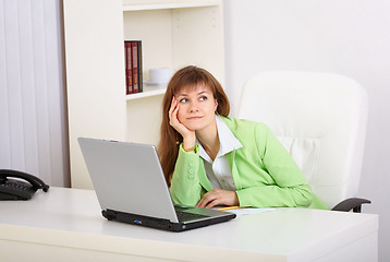 Image showing Dreamy woman in office