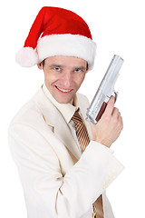 Image showing Merry guy in Christmas hat with a gun