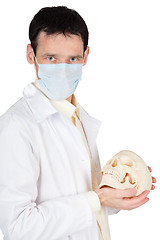 Image showing Young doctor in medical mask with a skull